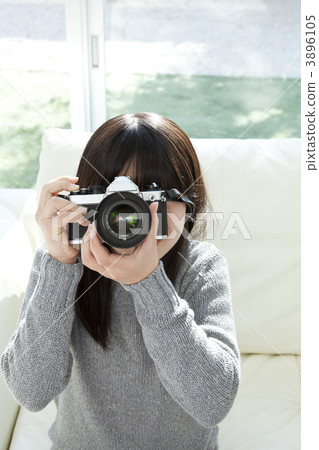 A girl looking through the camera's viewfinder A girl looking through the camera's viewfinder 3896105