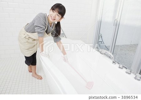 A girl cleaning a bath A girl cleaning a bath 3896534