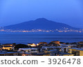 Italian town of Sorrento at night and the mountain of Vesuvius hoping over the Gulf of Naples 3926478