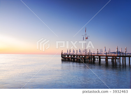 Pier lighted by sunrise glowing Pier lighted by sunrise glowing 3932463