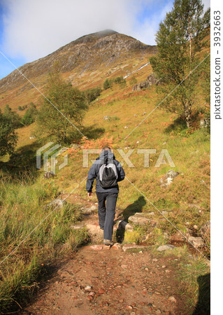 Man hiking through the Scottish hills 3932663