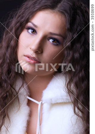 Young pretty girl close-up portrait in fur coat 3938699