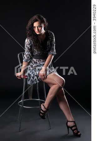 Beauty brunette sit on bar chair 3940229