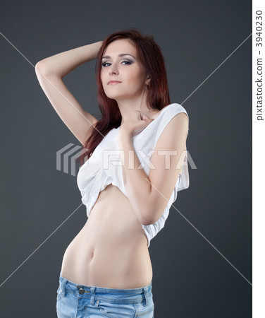 sexy young woman in jeans and tank top undress 3940230