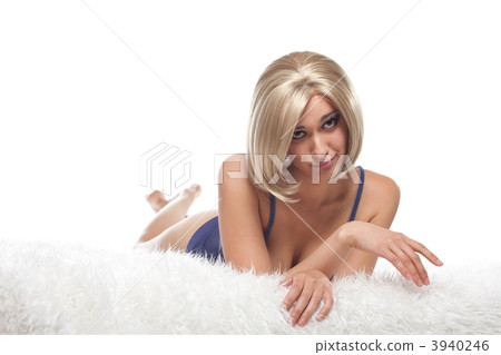Beauty blond woman lay on fur confused 3940246