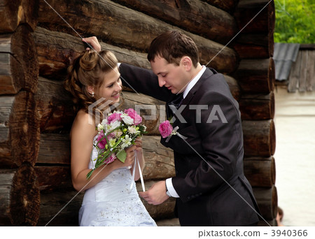 young wedding couple alone near wood house 3940366