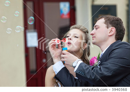 just married couple blow bubbles 3940368
