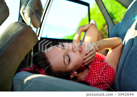 Young sexy woman lay in car - pinup style 3942644