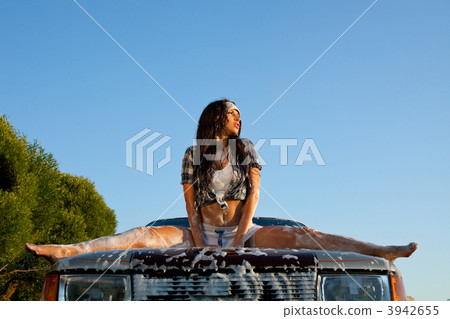 sexy woman washing a car at sunset 3942655