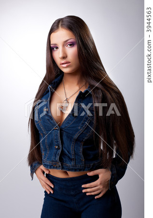 Sexy young brunette posing in jeans costume Sexy young brunette posing in jeans costume 3944563