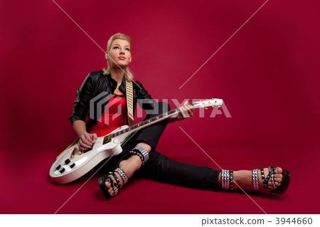 Sexy rock woman in corset sit with white guitar Sexy rock woman in corset sit with white guitar 3944660