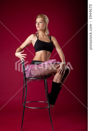young woman posing in dance sport costume on chair young woman posing in dance sport costume on chair 3944670