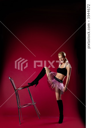 young woman in dance sport costume kick chair 3944672