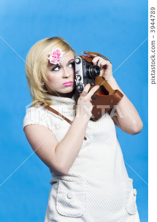 Blond girl with retro camera look aside Blond girl with retro camera look aside 3944789