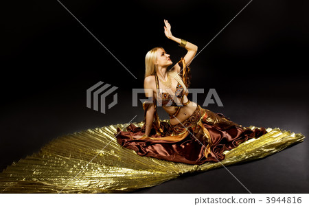 Young beauty woman lay on gold saber 3944816