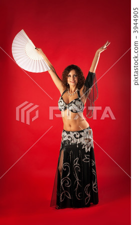 Woman in black arabian costume dance with fan 3944905