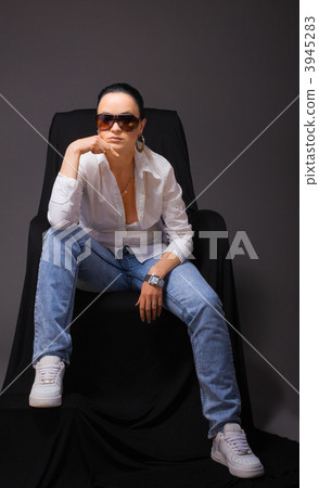 Young beauty woman sit in jeans and open shirt Young beauty woman sit in jeans and open shirt 3945283