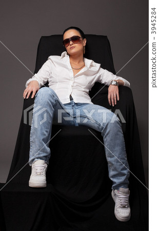 Young girl like tomboy sit on black chair Stock Photo 3945284  