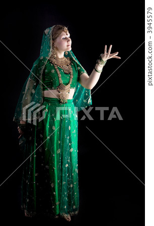 young girl in indian costume look at light 3945579