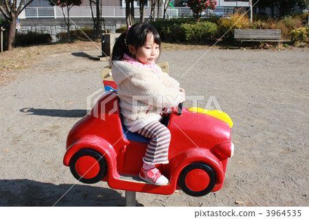 3 year old girl playing with spring type playground equipment 3 year old girl playing with spring type playground equipment 3964535