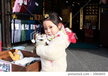 Three-year old child holding a cat stuffed animal 3968605
