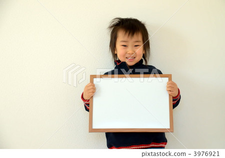 Child with message board with a smile Child with message board with a smile 3976921