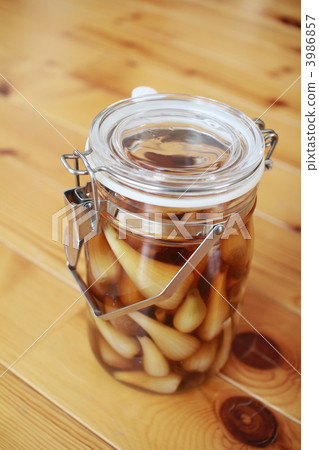A jar of homemade, pesticide-free pickled shallots in sweet vinegar A jar of homemade, pesticide-free pickled shallots in sweet vinegar 3986857