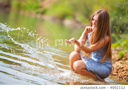 Young woman playing with water 4002112