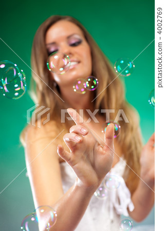 Young fashion woman with soap bubbles 4002769