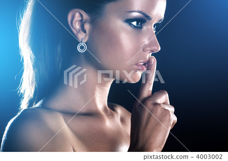 Young woman showing quiet handsign 4003002