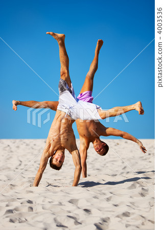 Two sportsmans on beach Two sportsmans on beach 4003536