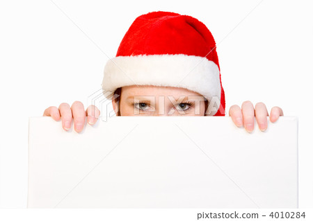 Christmas girl holding up a white sign for copyspace 4010284