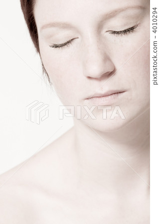 Studio portrait of a young woman with short hair relaxing 4010294