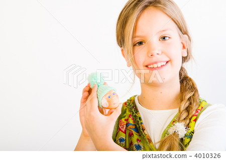 Young girl with painted egg with hat Young girl with painted egg with hat 4010326