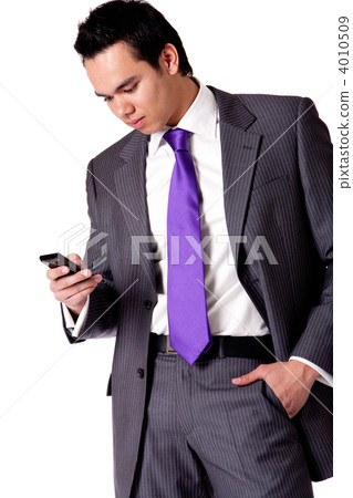 Strong young indonesian man in a suit checking his phone 4010509