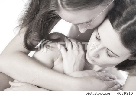 Two women holding on tihjt to each other 4039810