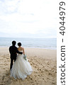 Bride and groom looking at the sea 4044979