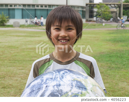 A boy with a ball shaped like the earth A boy with a ball shaped like the earth 4056223