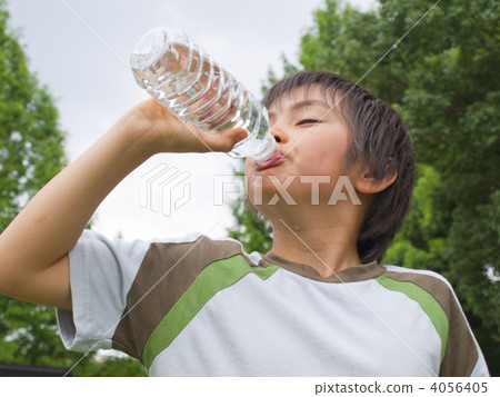 A boy drinking water of a plastic bottle A boy drinking water of a plastic bottle 4056405