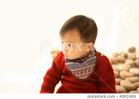 A 1 year old baby surrounded by wooden toys 4061069