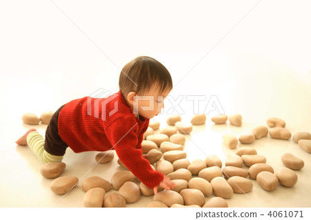 1 year old baby playing with wooden toy 4061071