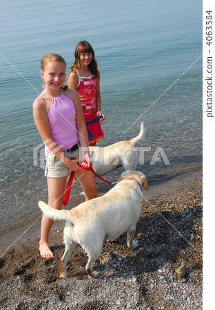 Two girls playing with dogs 4063584