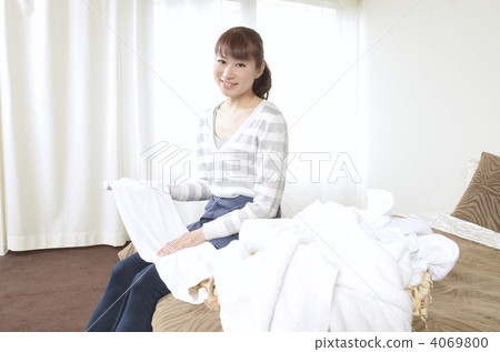 A woman folding laundry A woman folding laundry 4069800