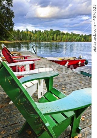 Deck chairs on dock at lake 4076523
