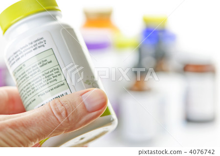 Hand holding medicine bottle Hand holding medicine bottle 4076742