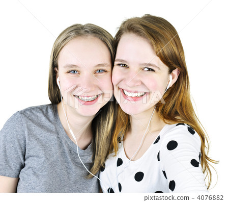 Two teenage girls listening to music Two teenage girls listening to music 4076882