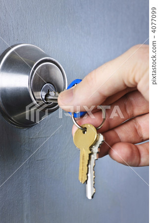 Hand inserting keys in lock Hand inserting keys in lock 4077099
