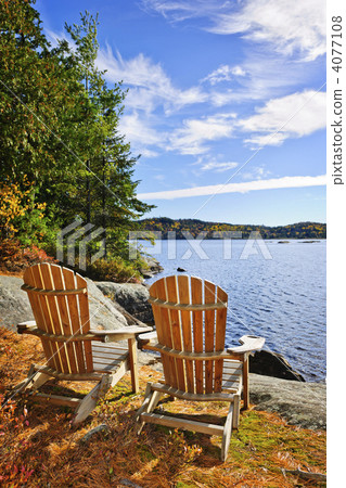 Adirondack chairs at lake shore Adirondack chairs at lake shore 4077108