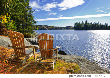 Adirondack chairs at lake shore Adirondack chairs at lake shore 4077120