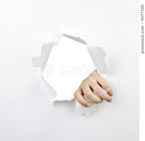 Hand ripping through hole in paper 4077160